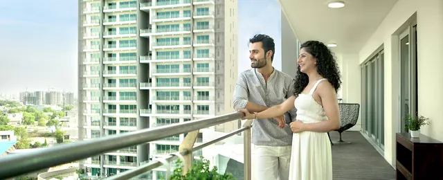 Tata Gurgaon Gateway - banner: couple on balcony with towers (lifestyle, 1920px) thumbnail
